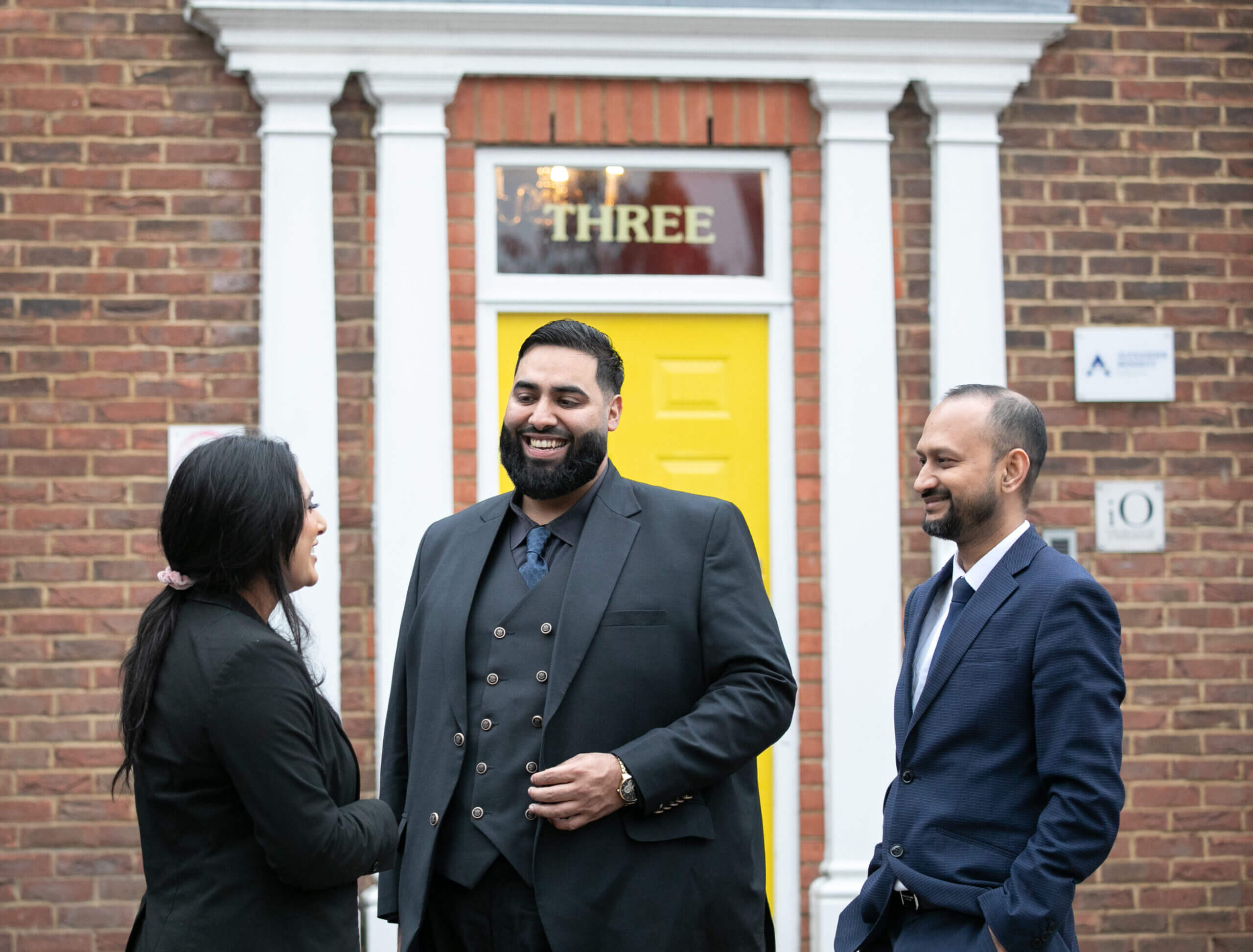 Solicitors talking outside outside a building.