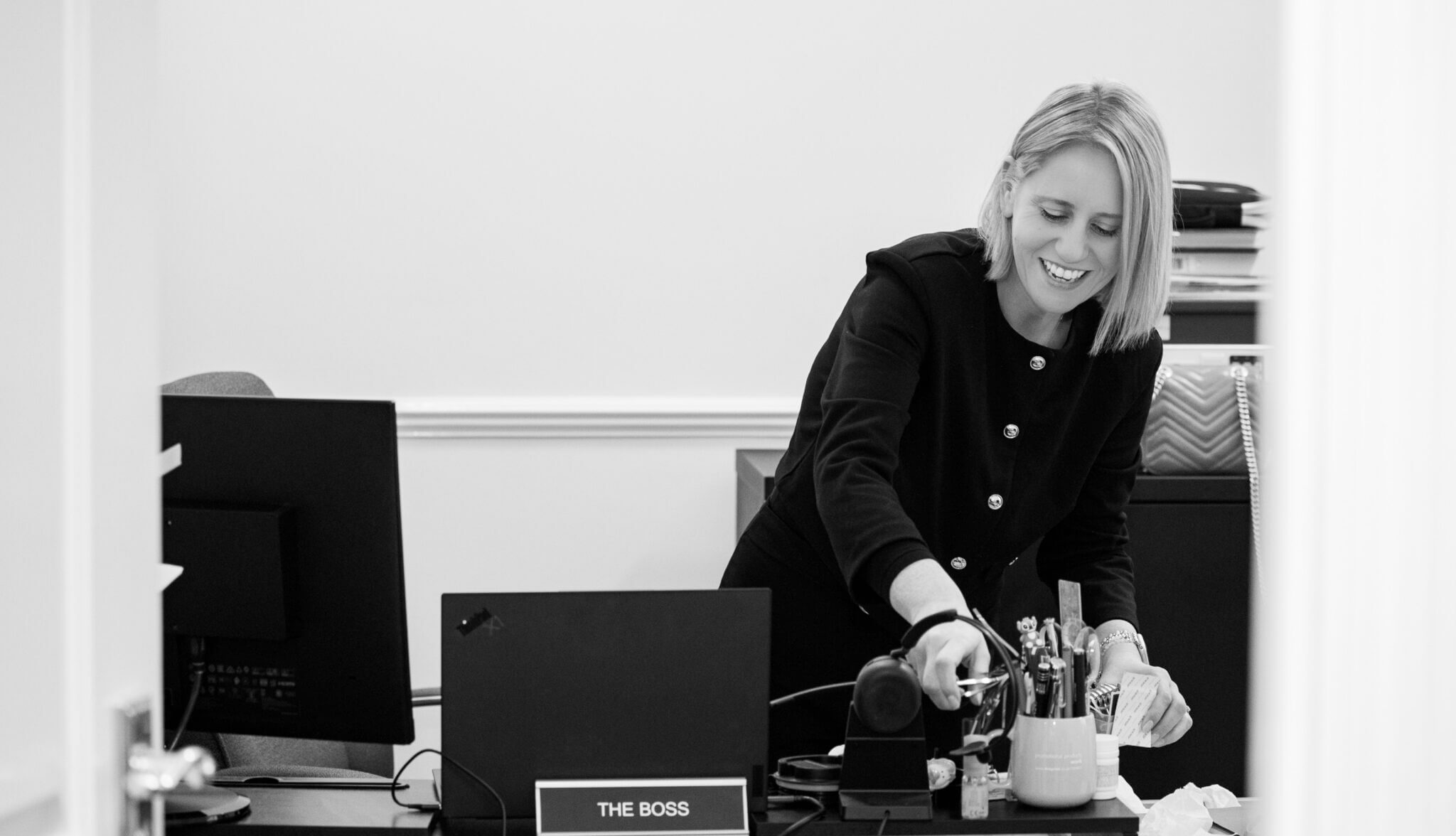 Mary Tmaira, Managing Partner of Alexander Bennett Solicitors, standing behind her desk.