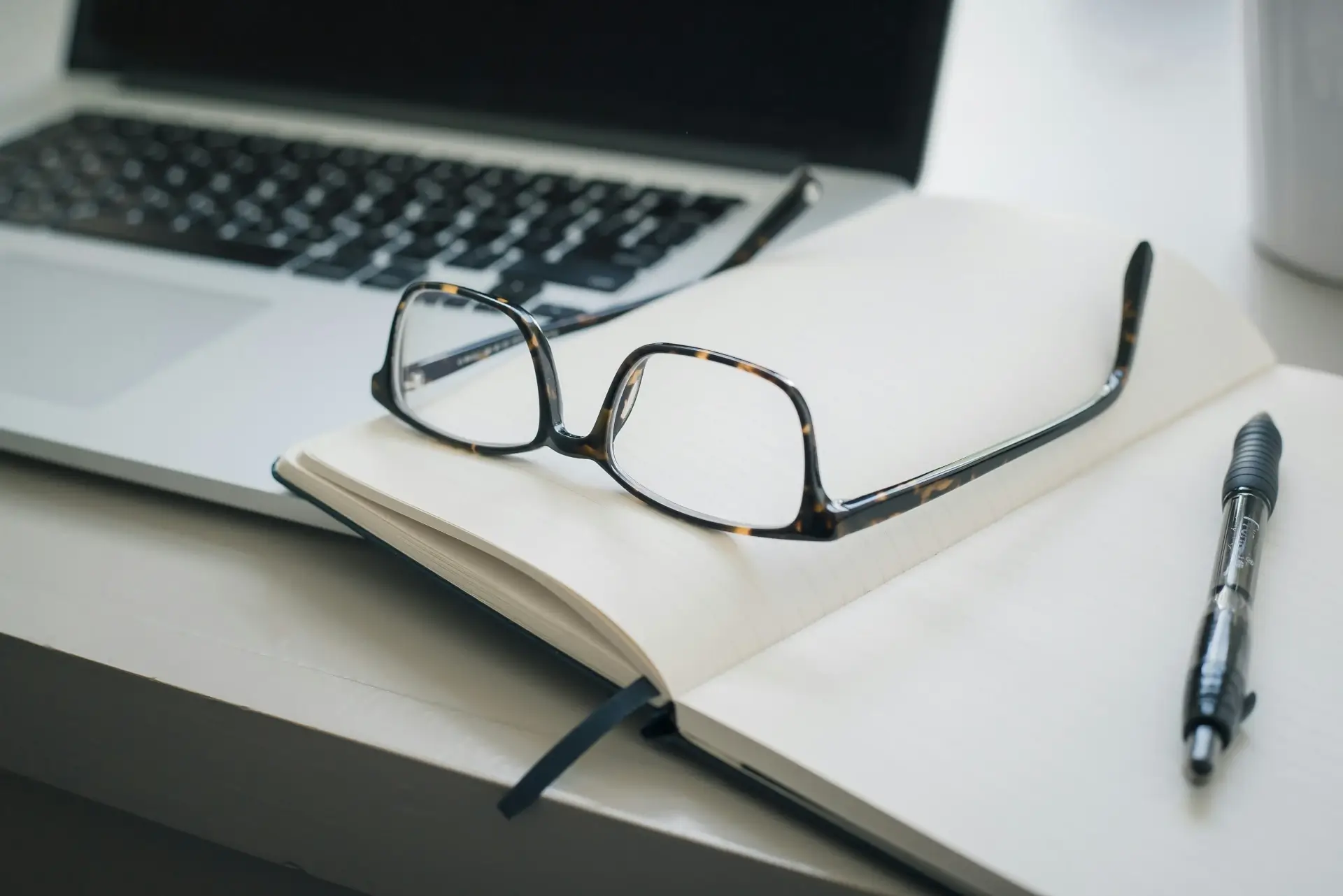 open notebook with glasses on top