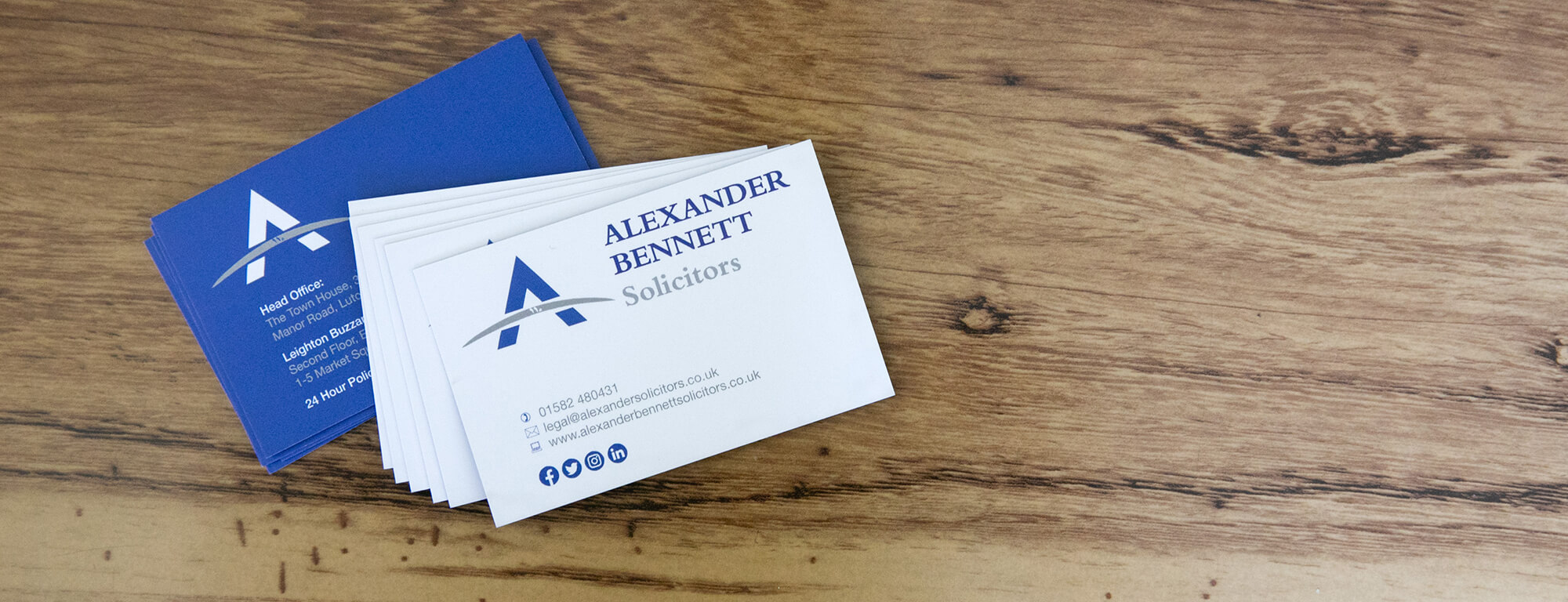 Alexander Bennett Solicitors business cards, in blue and white.
